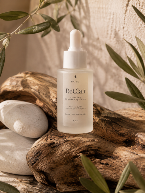 ReClair skincare serum bottle on a wooden surface with natural elements