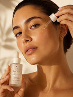 Woman applying skincare product with ReClair dropper bottle against a neutral background